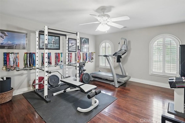 workout room featuring baseboards, wood finished floors, and a ceiling fan