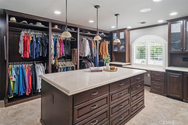 walk in closet featuring light carpet