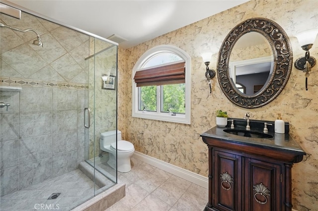 bathroom featuring a stall shower, toilet, baseboards, and vanity