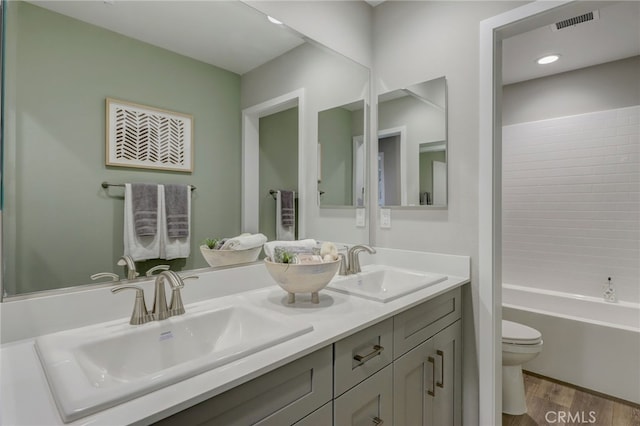 30973 Avenida Ramblas, Highland, CA 92346 - bathroom featuring a sink, toilet, wood finished floors, and visible vents