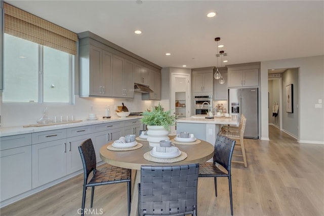30973 Avenida Ramblas, Highland, CA 92346 - kitchen featuring recessed lighting, light countertops, gray cabinets, under cabinet range hood, and stainless steel appliances
