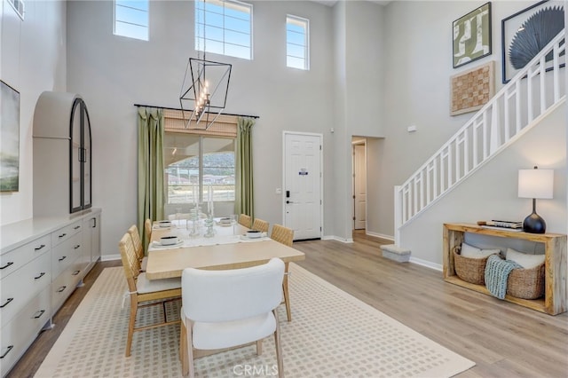 30973 Avenida Ramblas, Highland, CA 92346 - dining area with a healthy amount of sunlight, light wood finished floors, stairs, and a towering ceiling