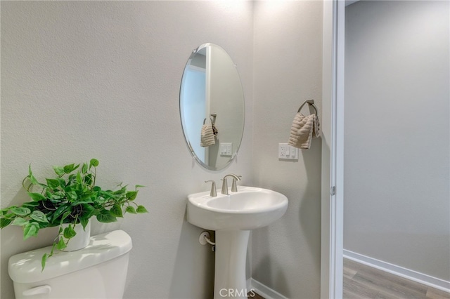 30973 Avenida Ramblas, Highland, CA 92346 - half bathroom with baseboards, wood finished floors, and toilet