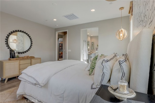 30973 Avenida Ramblas, Highland, CA 92346 - bedroom featuring visible vents, recessed lighting, ensuite bath, and wood finished floors