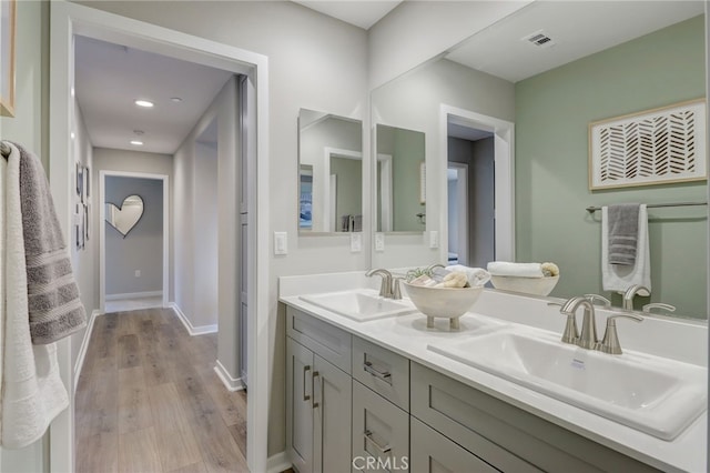 30973 Avenida Ramblas, Highland, CA 92346 - bathroom with a sink, double vanity, wood finished floors, and visible vents