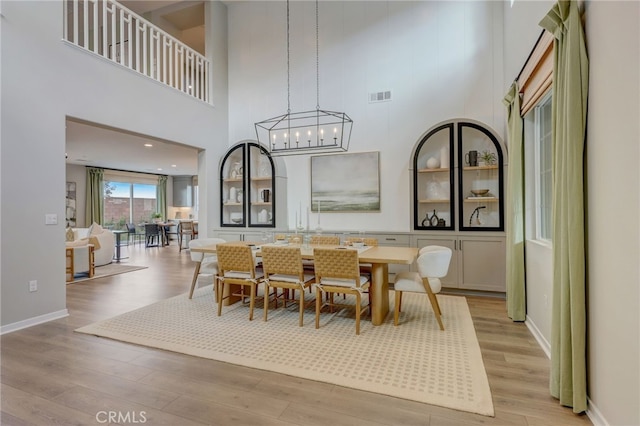 30973 Avenida Ramblas, Highland, CA 92346 - dining space with a towering ceiling, baseboards, light wood-style flooring, and visible vents
