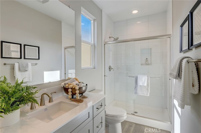 30973 Avenida Ramblas, Highland, CA 92346 - full bath with vanity, wood finished floors, toilet, recessed lighting, and a shower stall