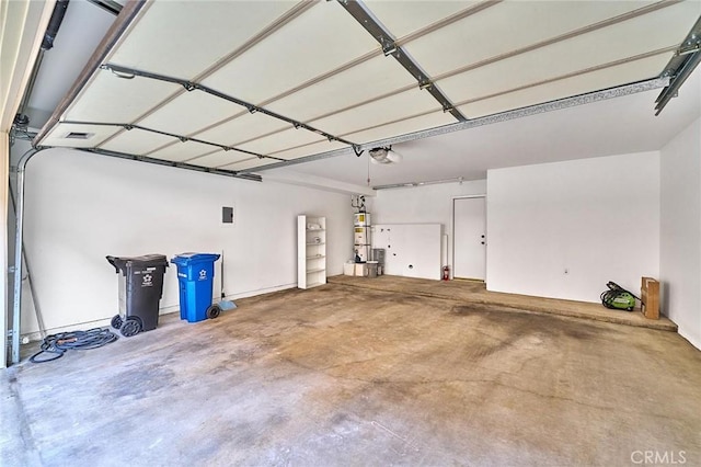 garage featuring water heater and a garage door opener