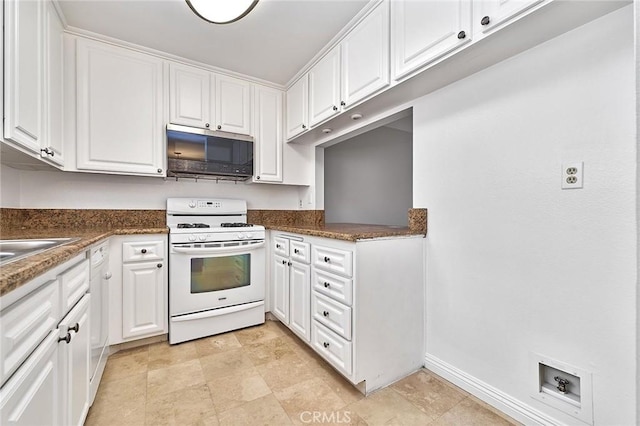 kitchen with baseboards, white range with gas stovetop, and white cabinets