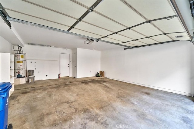 garage featuring visible vents, a garage door opener, and water heater