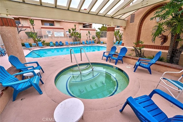 pool with fence, a community hot tub, and a patio area