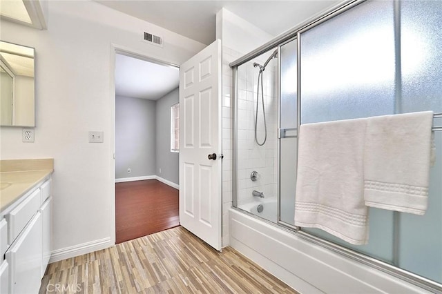 full bath with visible vents, baseboards, wood finished floors, and vanity