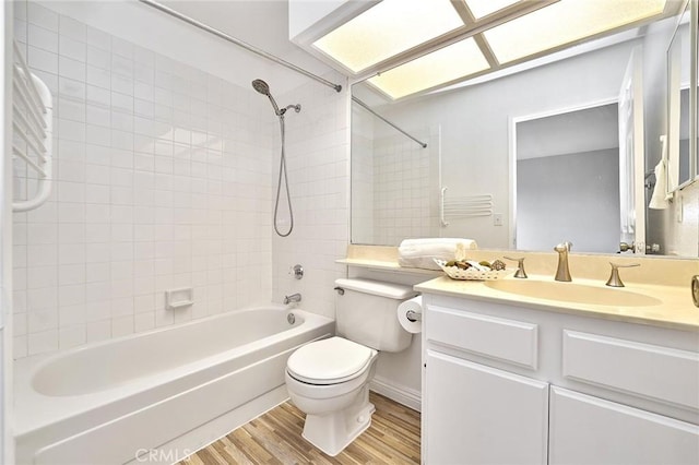 full bathroom featuring shower / bath combination, wood finished floors, toilet, and vanity