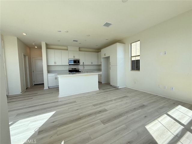 15893 Blue Copper Way, Fontana, CA 92336 - kitchen featuring appliances with stainless steel finishes, white cabinets, recessed lighting, light wood-style floors, and light countertops