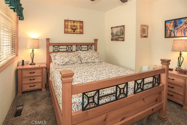bedroom featuring dark colored carpet and visible vents