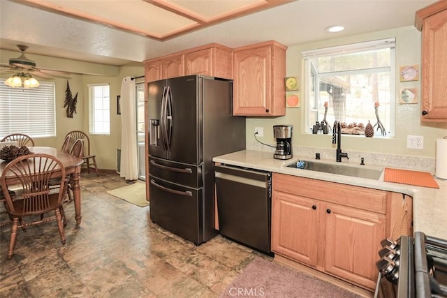 kitchen with a sink, stainless steel range with gas stovetop, dishwashing machine, light countertops, and light brown cabinetry