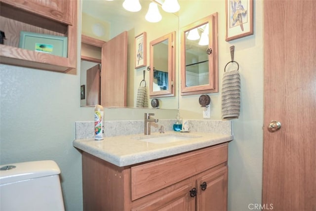 half bathroom featuring toilet and vanity