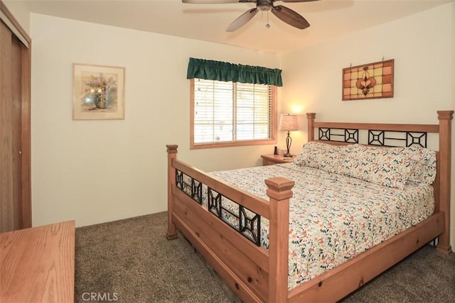 carpeted bedroom featuring a closet and ceiling fan