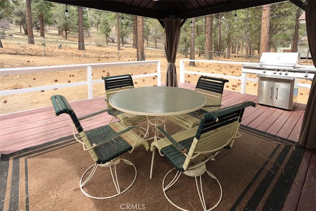 deck featuring fence, area for grilling, and outdoor dining space