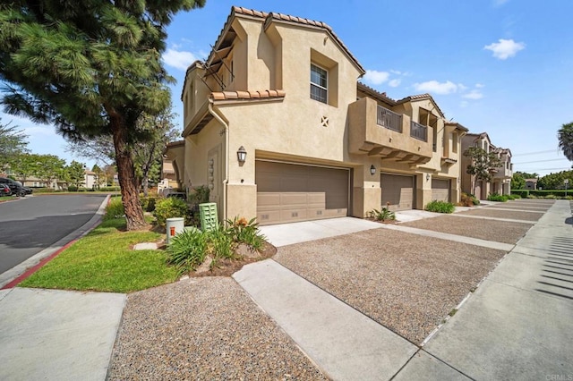 view of front of home with a garage, stucco siding, a residential view, concrete driveway, and a tile roof