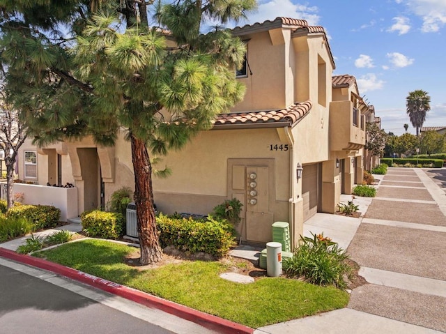 view of property featuring a garage and concrete driveway