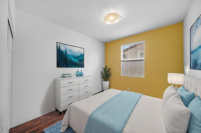 bedroom with dark wood finished floors