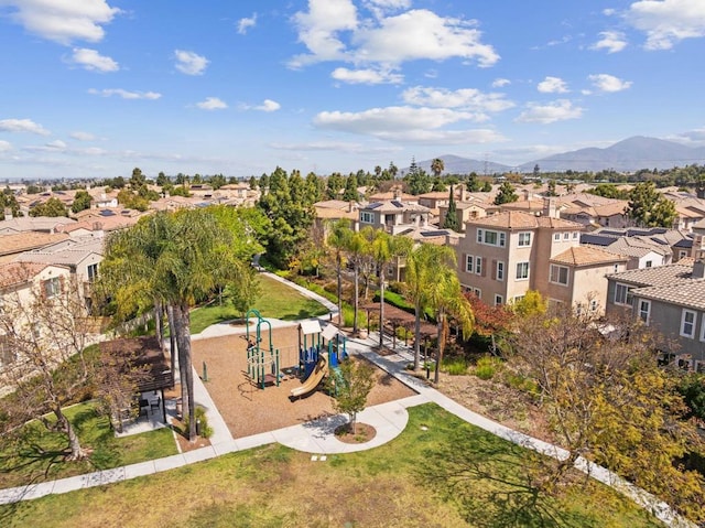 drone / aerial view featuring a residential view and a mountain view