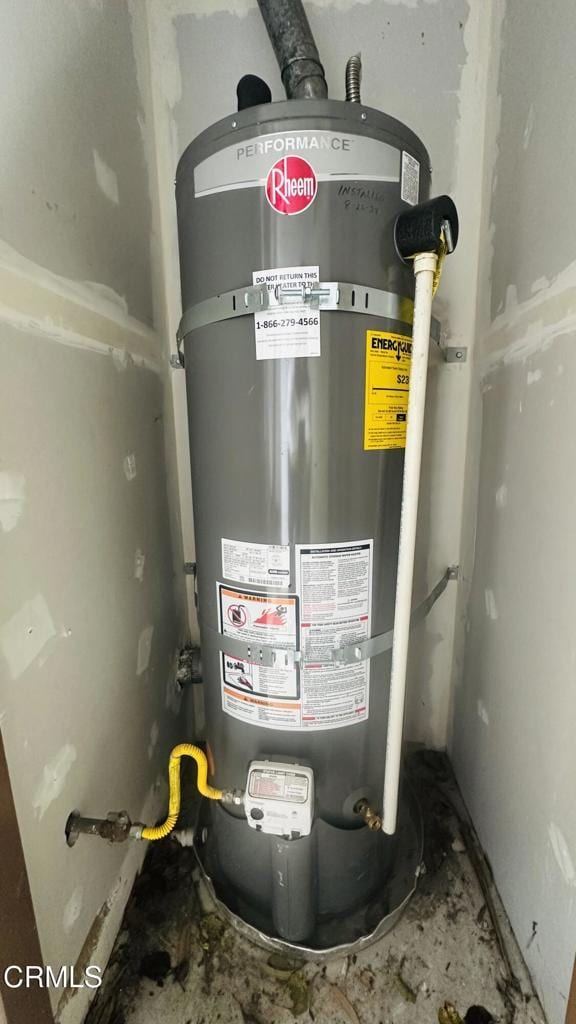 utility room with water heater