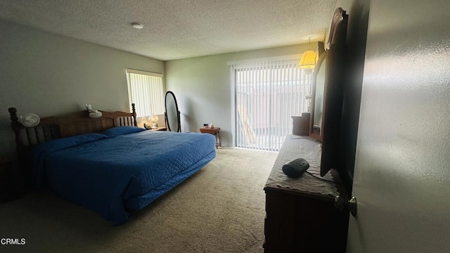 carpeted bedroom featuring a textured ceiling
