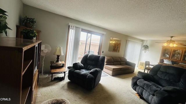 carpeted living room with a ceiling fan and a textured ceiling