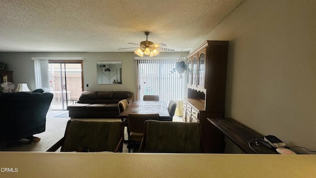 interior space with a ceiling fan, a textured ceiling, and carpet