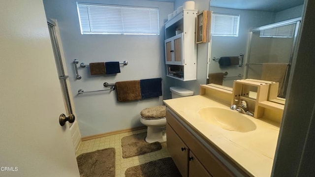 full bath with vanity, toilet, tile patterned floors, baseboards, and a shower stall