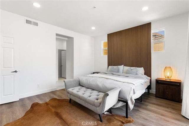 bedroom with recessed lighting, baseboards, visible vents, and wood finished floors