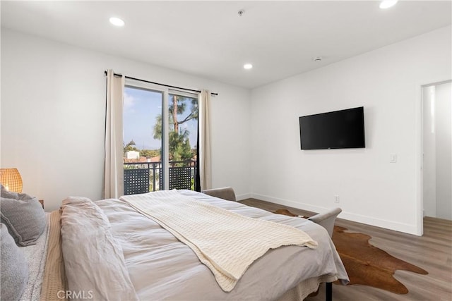 bedroom featuring recessed lighting, baseboards, wood finished floors, and access to exterior
