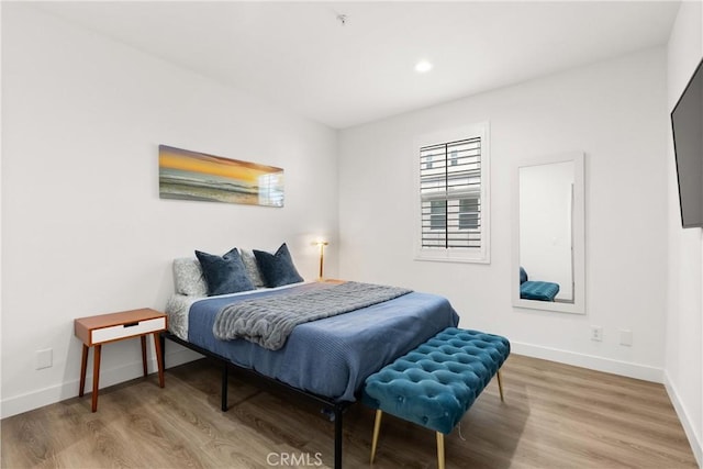 bedroom featuring baseboards, recessed lighting, and wood finished floors