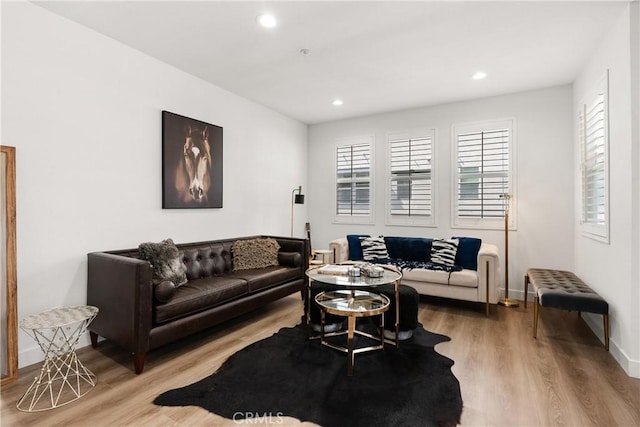 living area with recessed lighting, baseboards, and wood finished floors