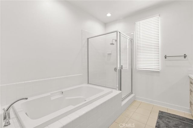 bathroom with a stall shower, tile patterned flooring, a bath, and vanity