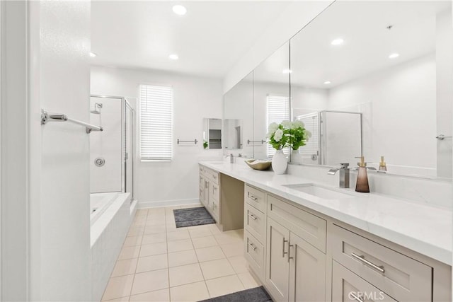 bathroom featuring a sink, a shower stall, recessed lighting, and double vanity