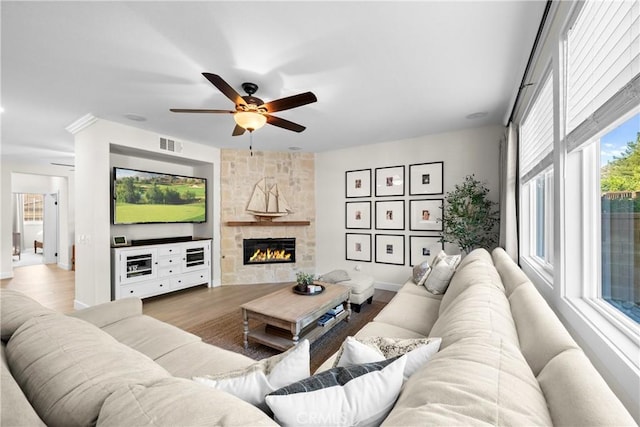 26544 Mahonia Way, Murrieta, CA 92562 - living area featuring a ceiling fan, wood finished floors, and a stone fireplace
