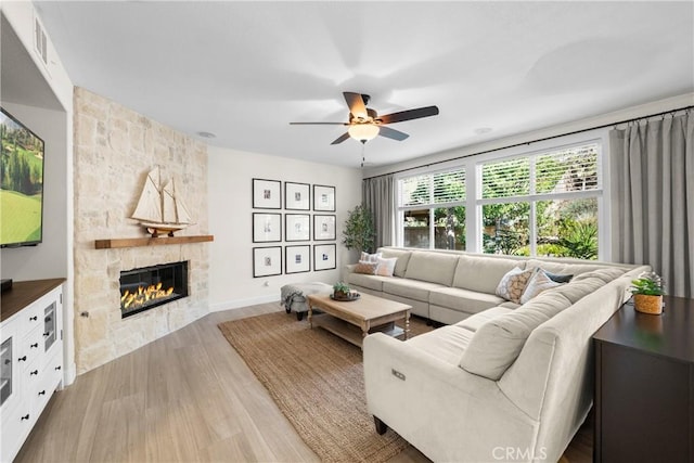 26544 Mahonia Way, Murrieta, CA 92562 - living room with wood finished floors, ceiling fan, and a stone fireplace