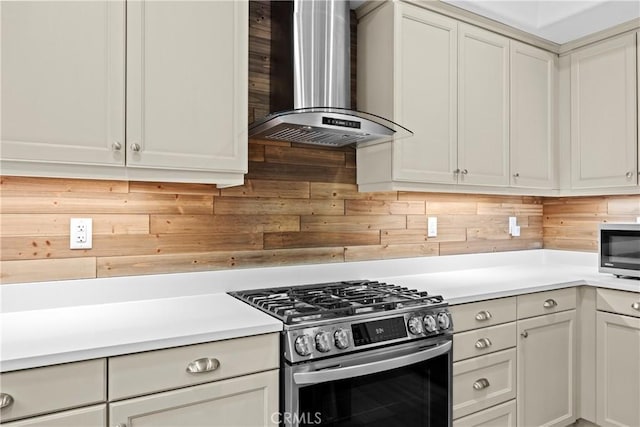 26544 Mahonia Way, Murrieta, CA 92562 - kitchen featuring stainless steel gas range, range hood, light countertops, and decorative backsplash