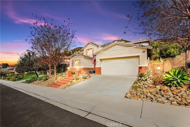 26544 Mahonia Way, Murrieta, CA 92562 - view of front of house featuring a garage, stucco siding, concrete driveway, and stone siding