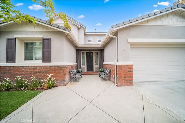 26544 Mahonia Way, Murrieta, CA 92562 - view of front of house featuring a garage, stucco siding, driveway, brick siding, and a tiled roof