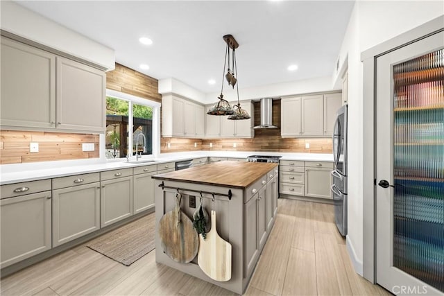26544 Mahonia Way, Murrieta, CA 92562 - kitchen with wood counters, wall chimney range hood, gray cabinetry, light wood finished floors, and recessed lighting