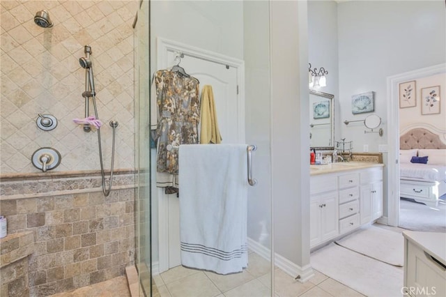 bathroom with vanity, tile patterned flooring, and tiled shower