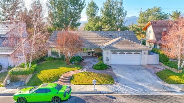 single story home featuring stucco siding, driveway, a front yard, and a garage
