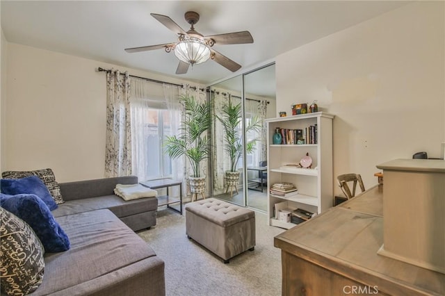 living room with carpet floors and a ceiling fan