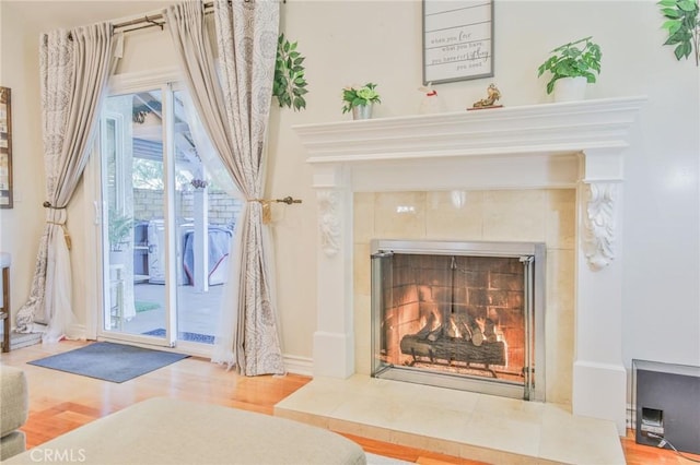 room details with a tiled fireplace and wood finished floors