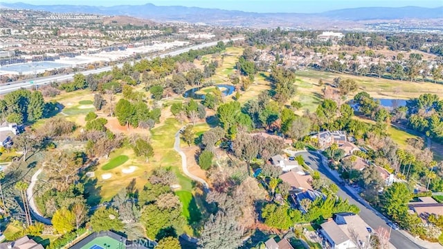 birds eye view of property with a water and mountain view and golf course view
