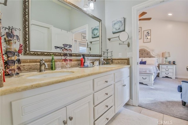 ensuite bathroom with a sink, tile patterned floors, ensuite bath, and double vanity
